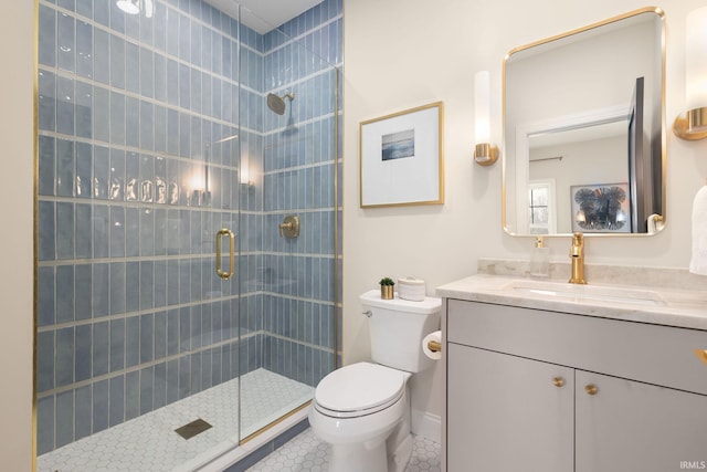 full bath with tile patterned floors, toilet, a shower stall, baseboards, and vanity