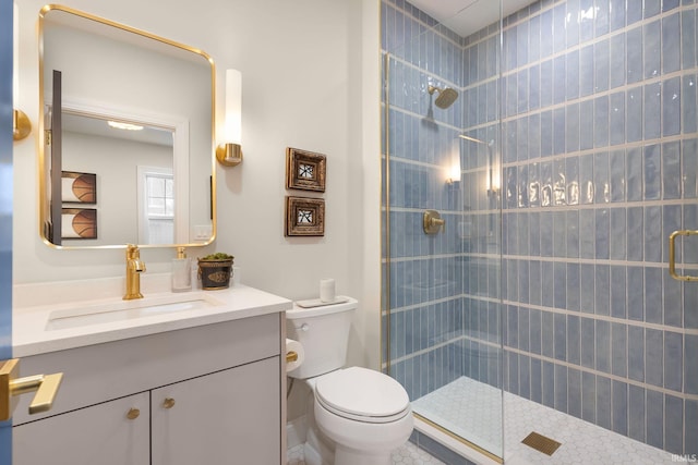 full bathroom with vanity, toilet, and a tile shower