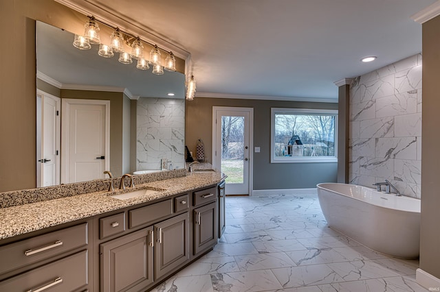 bathroom featuring baseboards, ornamental molding, a soaking tub, marble finish floor, and vanity