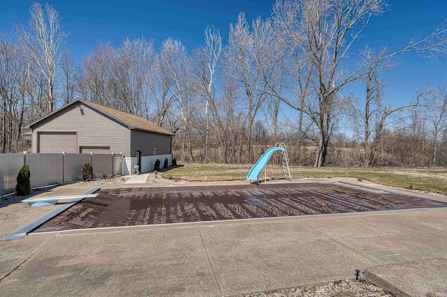 exterior space with a detached garage and fence