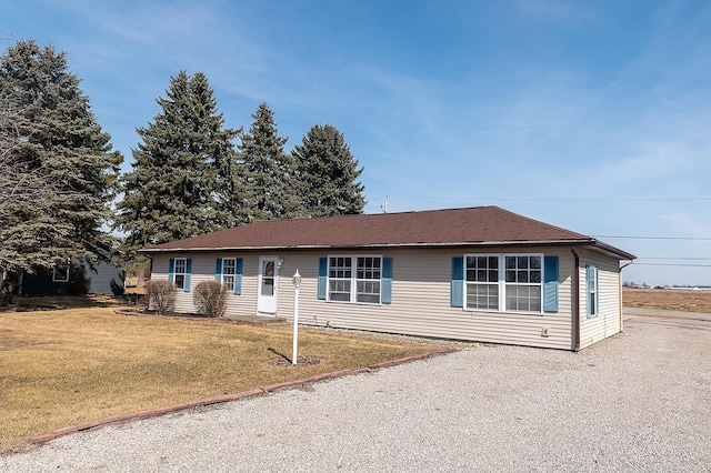 single story home featuring driveway and a front lawn