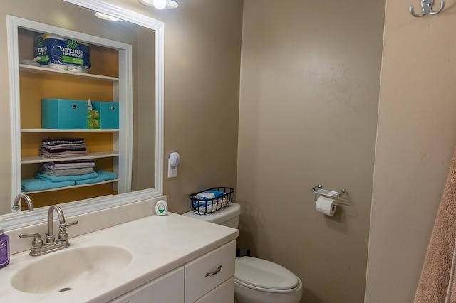 bathroom with toilet and vanity