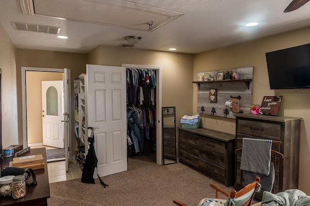 interior space featuring recessed lighting, light colored carpet, visible vents, and a closet