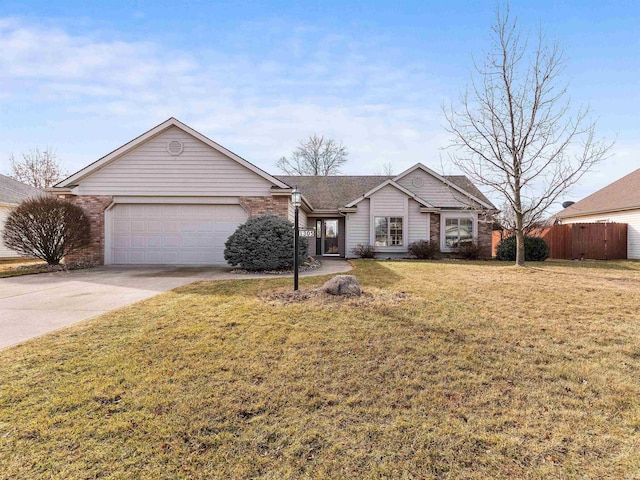 ranch-style home with a front yard, fence, driveway, an attached garage, and brick siding