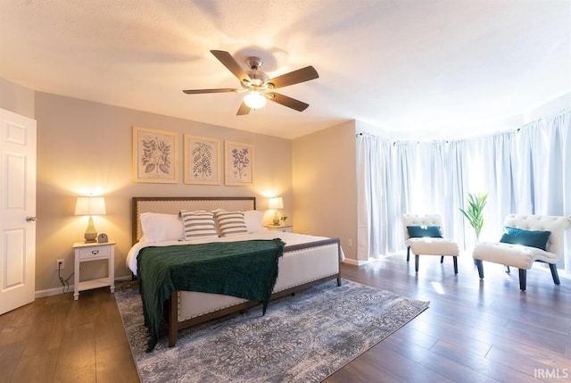 bedroom with ceiling fan, baseboards, and hardwood / wood-style floors