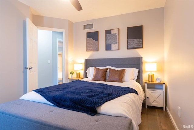 bedroom with visible vents, a ceiling fan, baseboards, and wood finished floors