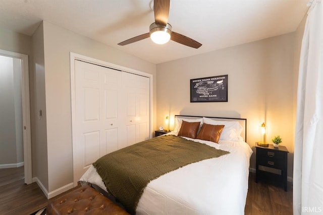 bedroom with a closet, baseboards, dark wood-style floors, and a ceiling fan