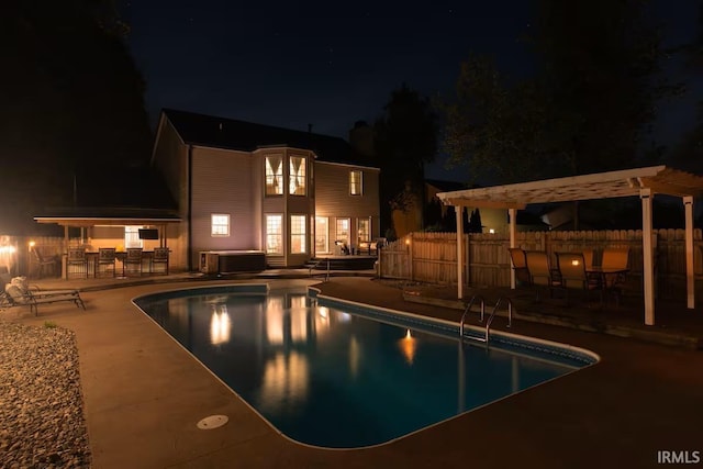 pool at twilight with a fenced in pool, a hot tub, fence, a patio area, and a pergola