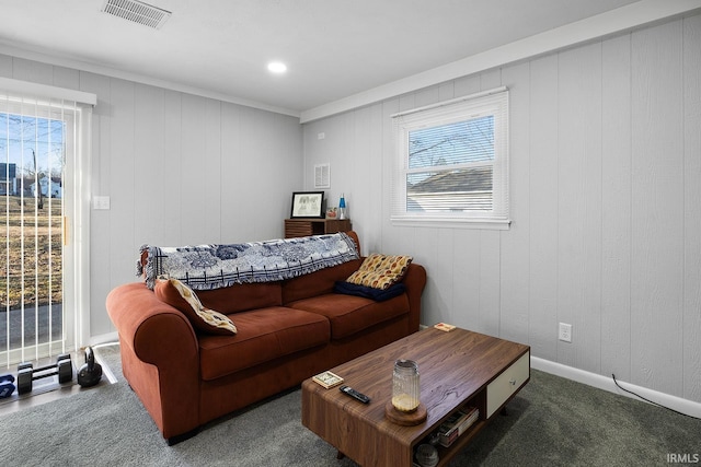 carpeted living room with plenty of natural light, baseboards, and visible vents