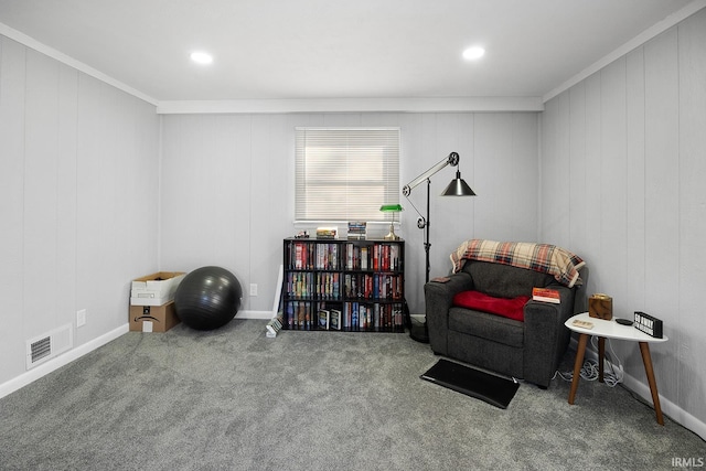 living area featuring crown molding, carpet flooring, baseboards, and visible vents