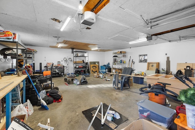 garage with a workshop area and a garage door opener