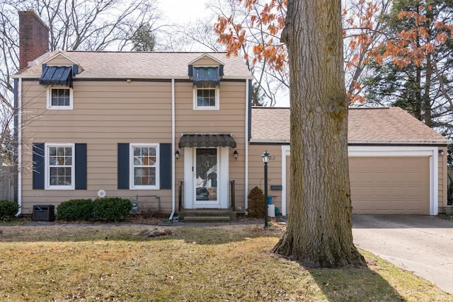 view of front of property featuring roof with shingles, a chimney, concrete driveway, a front lawn, and a garage