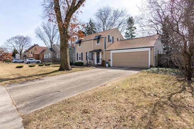 view of front of house with a front lawn, a garage, and driveway