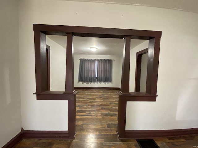 interior details with wood finished floors, baseboards, and visible vents