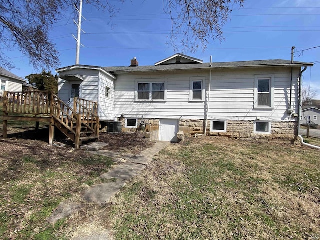 rear view of house featuring a wooden deck