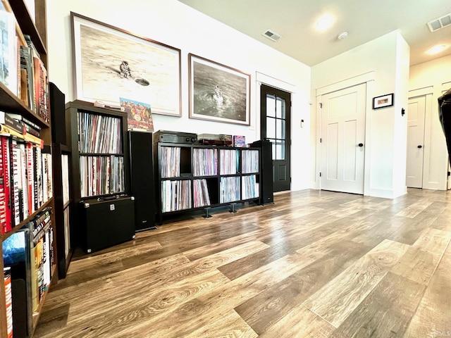 entryway with visible vents, baseboards, and wood finished floors