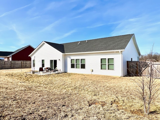 rear view of house featuring a patio and a fenced backyard