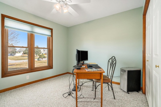 office area with ceiling fan, visible vents, baseboards, and light carpet