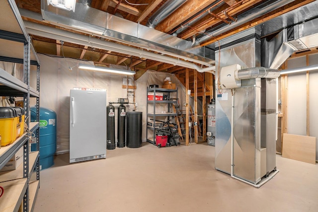 unfinished basement featuring heating unit and water heater