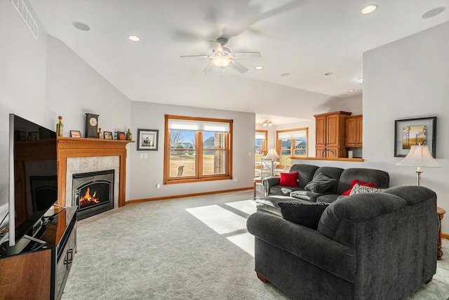 living area featuring baseboards, lofted ceiling, recessed lighting, light carpet, and a tiled fireplace