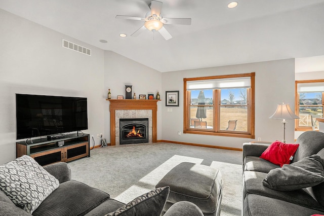 living area featuring a wealth of natural light, visible vents, carpet floors, and vaulted ceiling