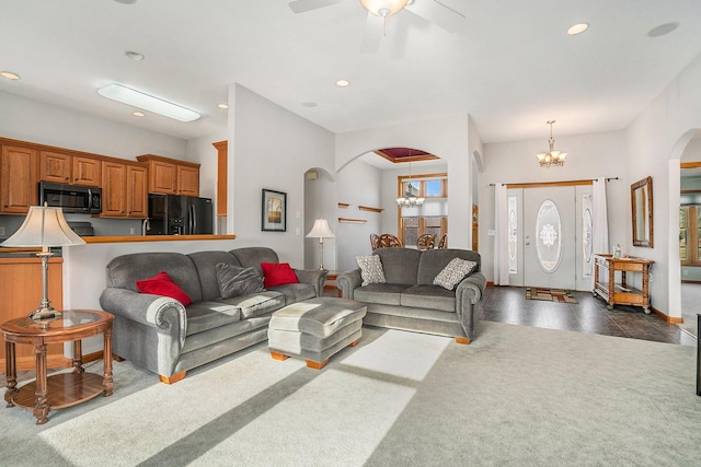 living area with arched walkways, plenty of natural light, and recessed lighting