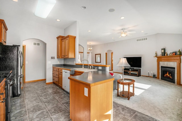 kitchen featuring arched walkways, visible vents, stainless steel range with gas stovetop, and a sink