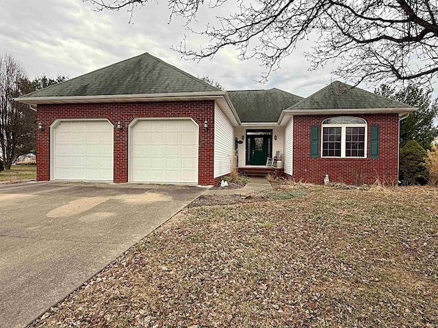 single story home with a garage, brick siding, driveway, and a shingled roof