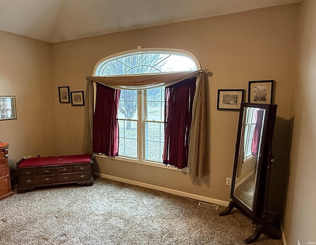 bedroom with vaulted ceiling, baseboards, and light carpet