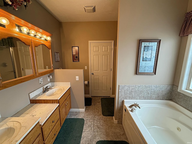 full bathroom featuring tile patterned floors, visible vents, a whirlpool tub, baseboards, and vanity