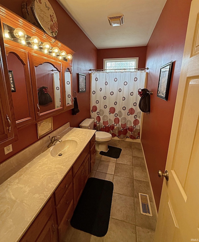 full bath featuring vanity, a shower with curtain, visible vents, tile patterned floors, and toilet