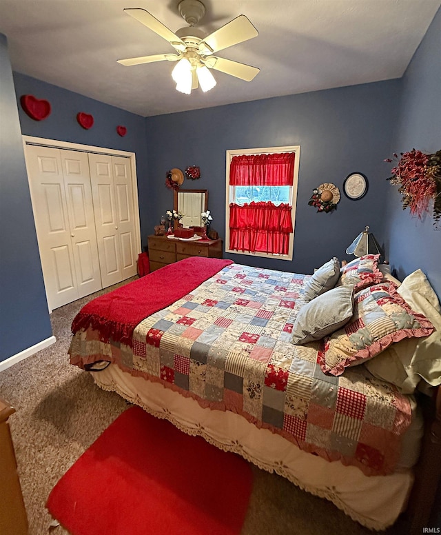 carpeted bedroom featuring a closet, baseboards, and a ceiling fan