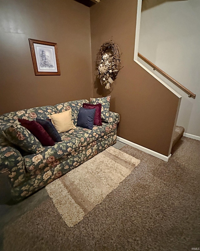 carpeted living area with stairway and baseboards