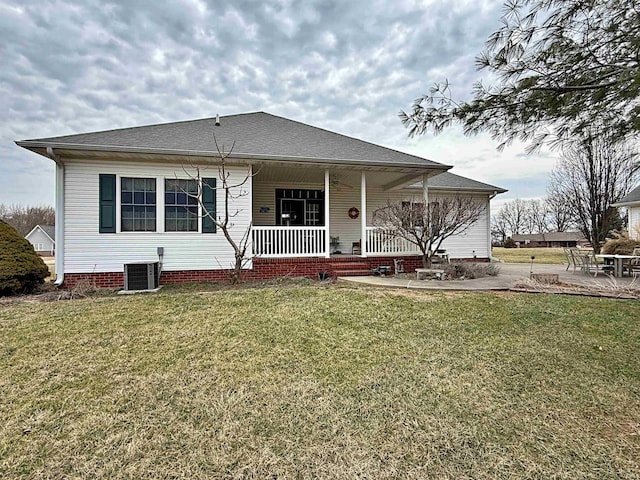 rear view of property featuring central air condition unit, a yard, a porch, and a patio area