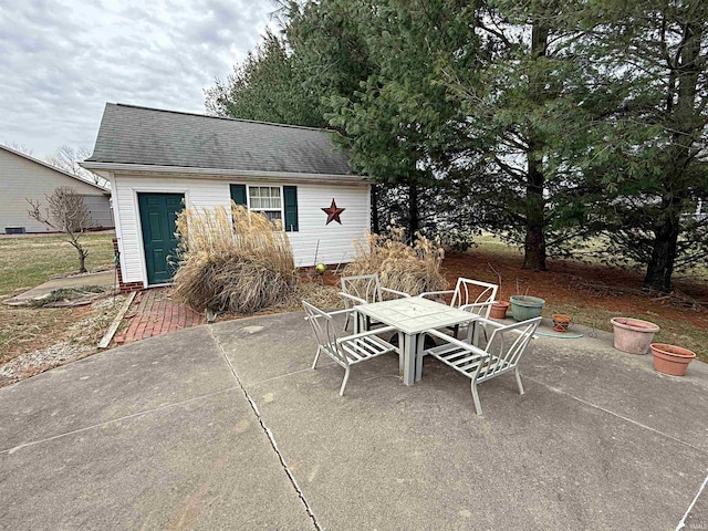 view of patio with outdoor dining area and an outdoor structure