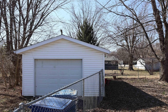 detached garage featuring fence