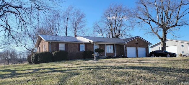 ranch-style home with a front lawn, an attached garage, brick siding, and metal roof