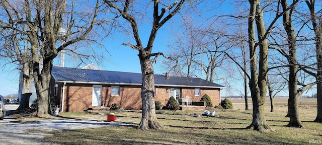 ranch-style home with brick siding and a front yard