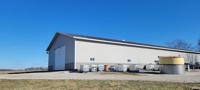 exterior space featuring a detached garage and an outbuilding