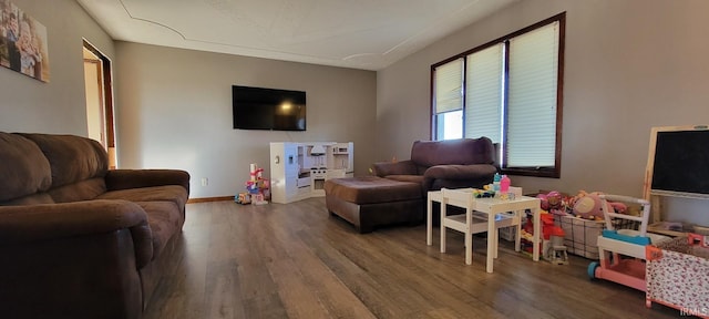 living room with baseboards and wood finished floors