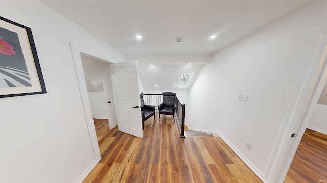 corridor featuring an upstairs landing, recessed lighting, baseboards, and wood finished floors