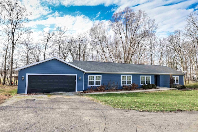 ranch-style house with aphalt driveway, an attached garage, and a front yard