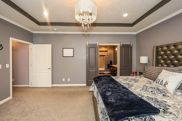 bedroom featuring a barn door, carpet, baseboards, and a raised ceiling