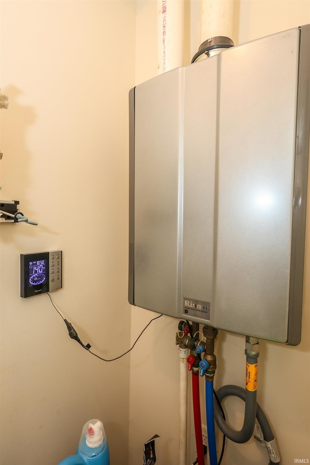 utility room with tankless water heater