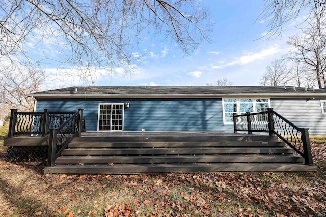 rear view of house featuring a wooden deck