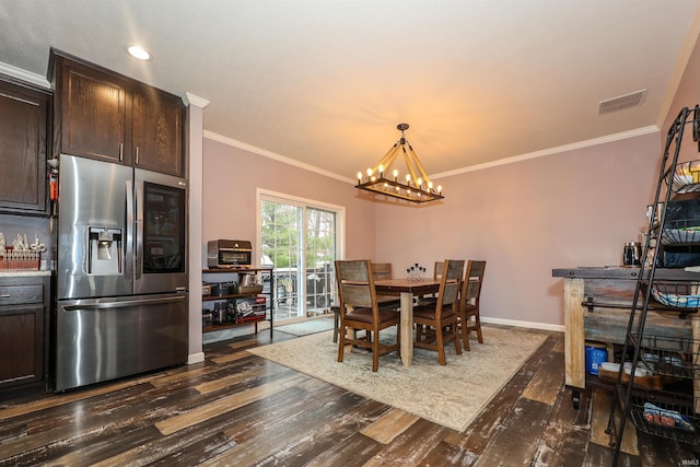 dining area with visible vents, baseboards, dark wood finished floors, and ornamental molding