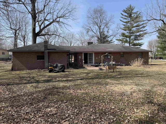 back of house featuring brick siding