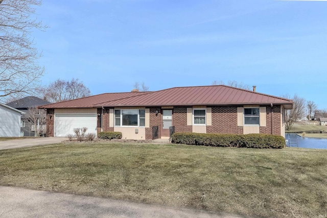 ranch-style house featuring brick siding, a front yard, metal roof, a garage, and driveway