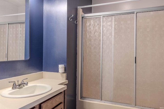 bathroom with vanity and a shower with shower door