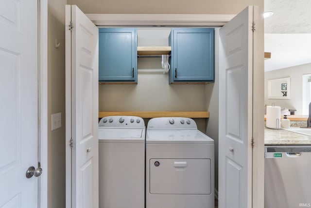 laundry area featuring washing machine and dryer and cabinet space